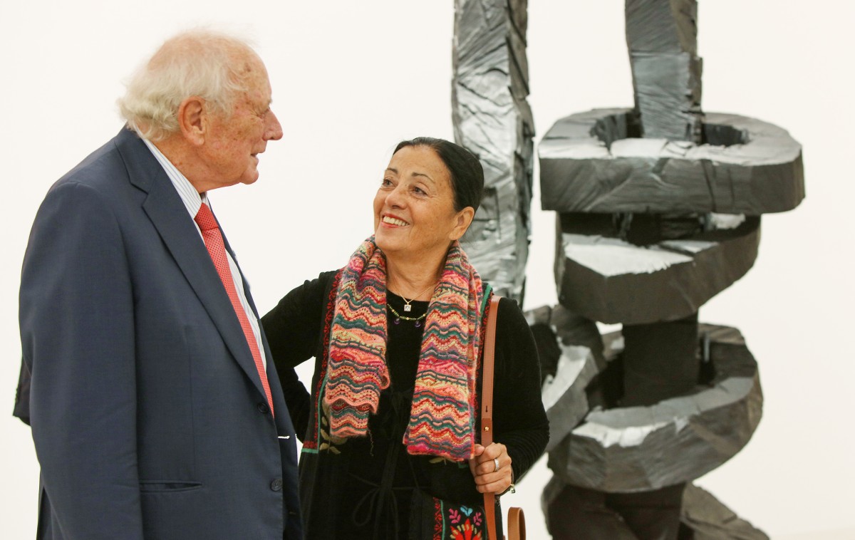 Reinhold and Carmen Würth at the opening of the art exhibition 'Lust auf mehr' in front of Georg Baselitz' sculpture 'Yellow Song' from the Würth Collection.